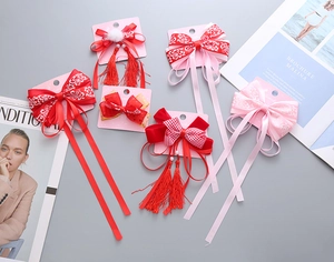 Set dettagliato di 6 fiocchi per capelli rossi stile cinese con nappe e pompon per bimbe