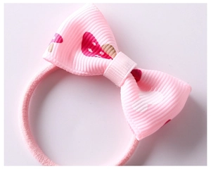 Close-up of pink bow hair tie with cute mushroom pattern and high elastic band detail