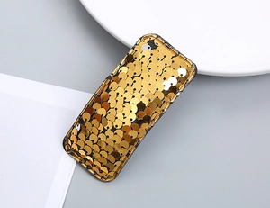 Detail view of rectangular gold sequin hair clip with black fabric edge for girls