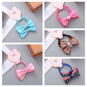 Close-up of five pairs of bowknot hair ties with striped patterns on display cards