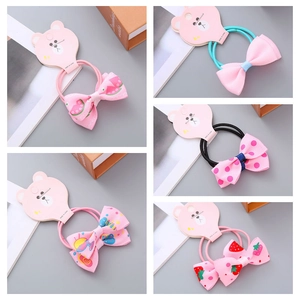 Detail of five assorted bow hair ties with strawberry, watermelon, and floral prints