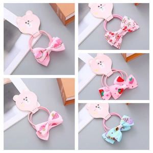 Detail of Korean-style bow hair ties with fruit prints and polka dots on bear card