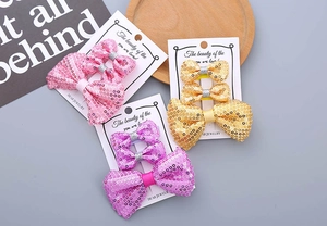 Detailliertes Set aus Glitzer-Haarschleifen für Mädchen in Rosa, Lila und Gold
