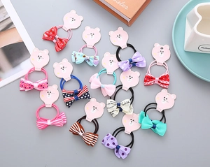 Close-up of 13-piece girls' bow hair ties featuring floral, stripe and polka dot patterns