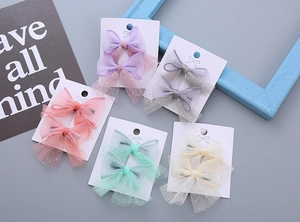 Detailed view of handmade mesh bow hair clips in five Morandi colors with gold sequins