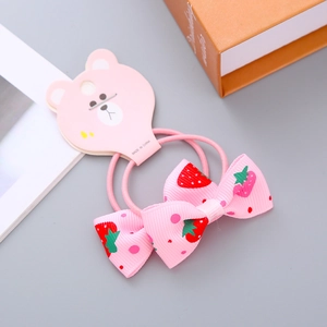 Pink strawberry print ribbon bow hair ties for girls on bear card packaging