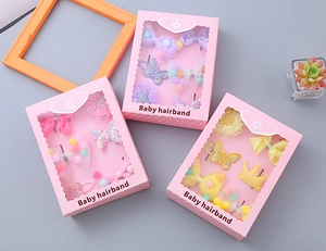 Detail view of 6-piece baby hair accessories gift set with bows and crowns in pink window box