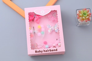Detailed view of a 6-piece pink baby hair accessories gift set in heart window box