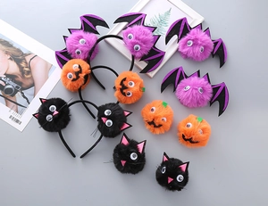 Detail of Halloween hair accessories with plush pom-poms, bats, pumpkins and cats