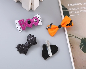 Detail of Halloween hair clips with glitter bats and purple BOO bows on metal alligator clips