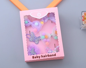 Detail view of 6-piece girls purple bow hair clip and scrunchie gift set in pink box