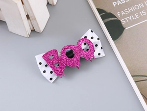 Detail of Halloween hair clip with polka dot bow and pink glitter BOO lettering