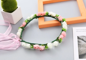 Detail of pink and white foam rose wreath with sheer ribbons for girls hair styling