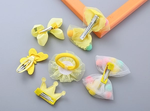 Detailed back view of girls' hair clip set showing clips and elastic band mechanisms