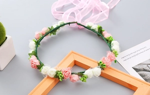 Detail of handmade floral crown with pink and white roses and soft organza ribbon ties