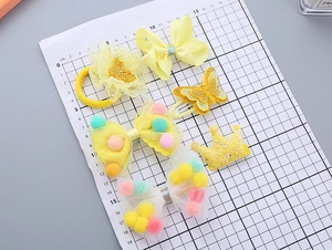 Detail of yellow girl's hair accessory set with mesh bows and crown hairpins