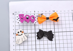 Detail of Halloween hair clips showing measurements on a grid for size reference