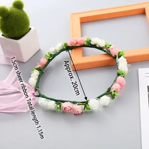 Floral headband with pink and white roses, green vines, and long pink organza ribbon