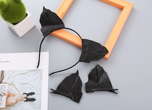 Detail of glittery black bat ear headband and hair clips set for Halloween party