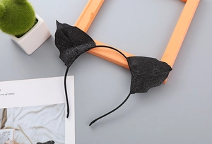 Close-up of black glittery bat ears headband with sparkling texture for Halloween