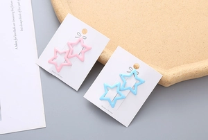 Gros plan de barrettes en forme d'étoile rose et bleue sur une carte de présentation