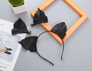 Detail of black glitter bat ears headband and hair clips for Halloween party costume