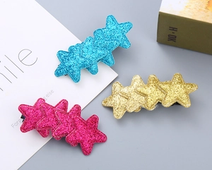 Detailed close-up of glitter star hair clips in blue, champagne gold, and rose purple set