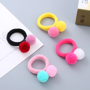 Set of 4 colorful fuzzy ball hair ties for girls featuring elastic bands in candy colors
