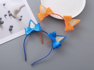 Dettaglio di cerchietti con orecchie di gatto glitterate e fiocchi blu e arancioni