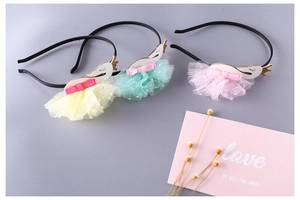 Detail of children's swan headbands in yellow, mint green, and pink with mesh tutus