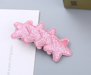 Detail showing four overlapping pink glitter star hair clips with a shiny finish