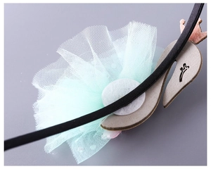 Detail of children swan headband with light green sequin mesh and crown motif