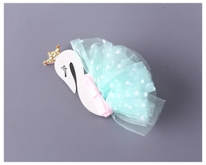 Close-up of pink sequin swan headband with gold crown and mint green polka dot mesh
