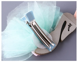 Detailed back view of kids swan hair clip with blue mesh and ribbon-wrapped metal clip
