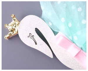 Detail of pink glitter swan headband with a gold crown and polka dot mint tulle mesh