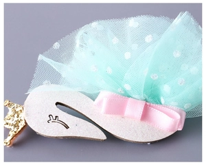 Detail of glitter swan hairband with mint green tulle and golden crown for girls