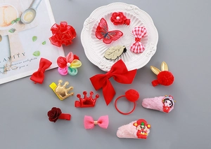 Detail shot of New Year hair clips with red bows, plush balls and traditional motifs