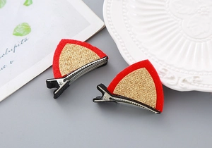 Detail of red cat ear hair clips with gold glitter inlay and silver alligator base