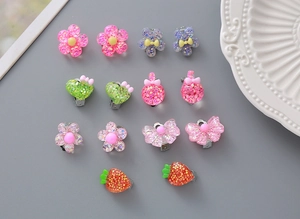 Detailed set of cute resin clip-on earrings for kids featuring colorful glitter patterns