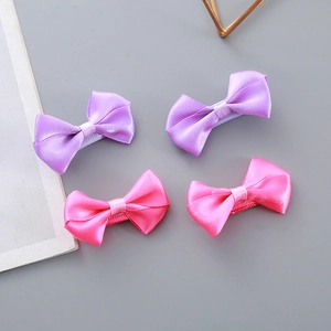 Set of four handmade satin bow hair clips in pink and purple for girls with silk finish