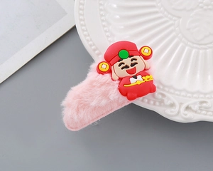 Close-up of pink plush hair clip featuring a cartoon God of Wealth for Lunar New Year