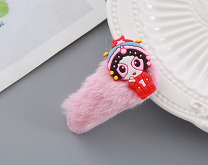 Close-up of a pink plush hair clip featuring a cute traditional Peking Opera cartoon character