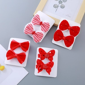 Set of 4 pairs of festive red velvet bow hair clips for girls with glittery details