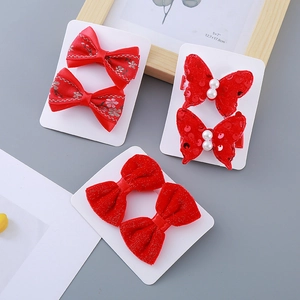 Red velvet and sequin butterfly hair clips set for girls on a white display card
