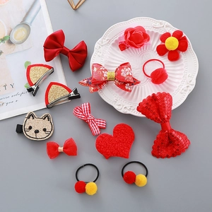 Festive red children's hair accessory set with bows and pompoms for New Year celebrations