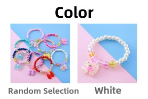 Detail of colorful children beaded bracelets with cute resin bows and strawberry charms