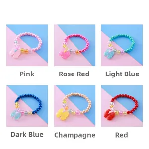 Detail view of six colorful beaded bracelets for children with cute resin bow charms