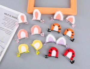 Flat lay of 12pcs plush cat and rabbit ear hair clips in vibrant colors for girls
