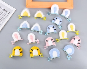 Flat lay of colorful plush animal ear hair clips featuring cat and rabbit designs