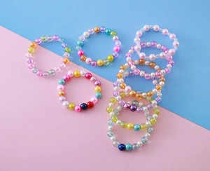 Gros plan de bracelets de perles colorés pour enfants avec breloques et perles
